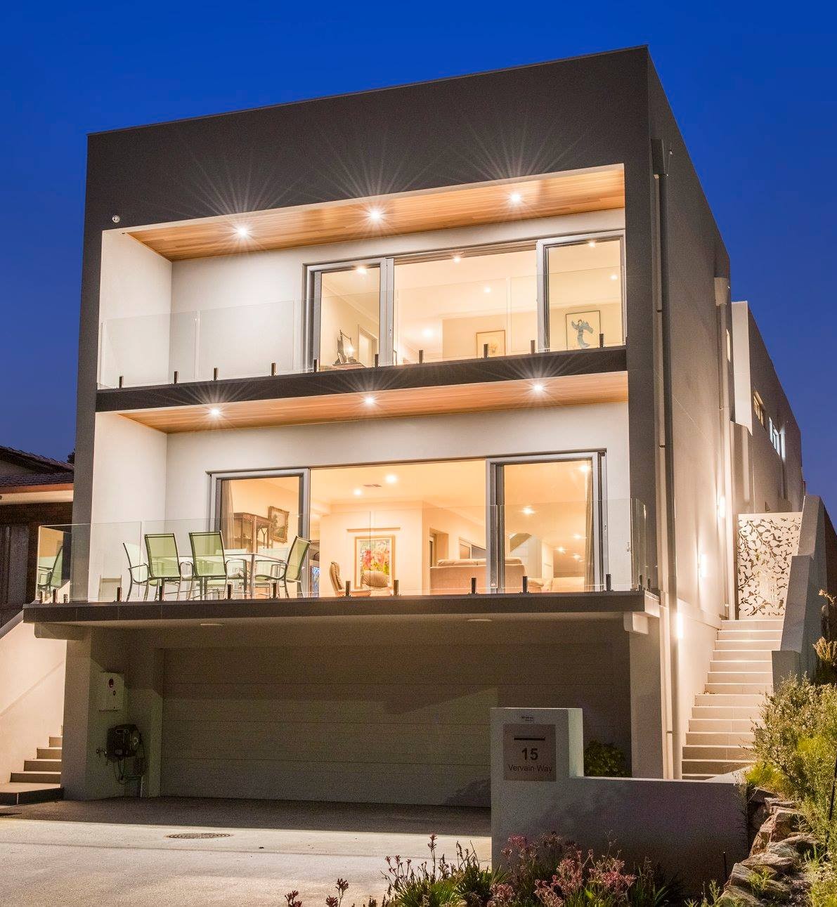 Eco home with rammed earth walls, solar panels, and native landscaping