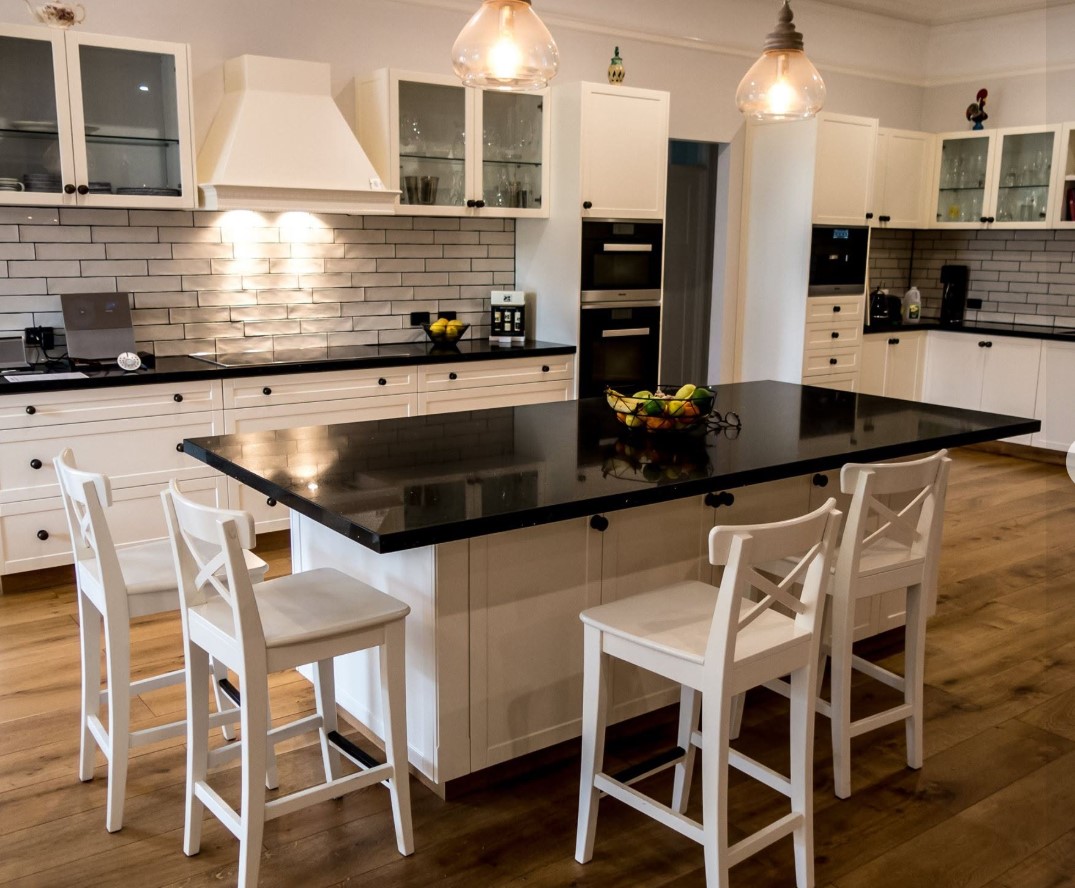 Shaker kitchen in a Federation home with subway tile splashback and black stone benchtops