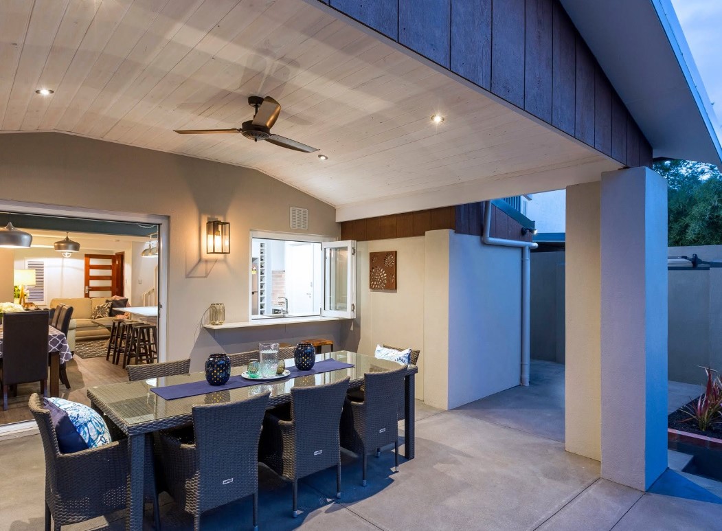 Covered alfresco extension with a timber-lined raked ceiling opening off the kitchen
